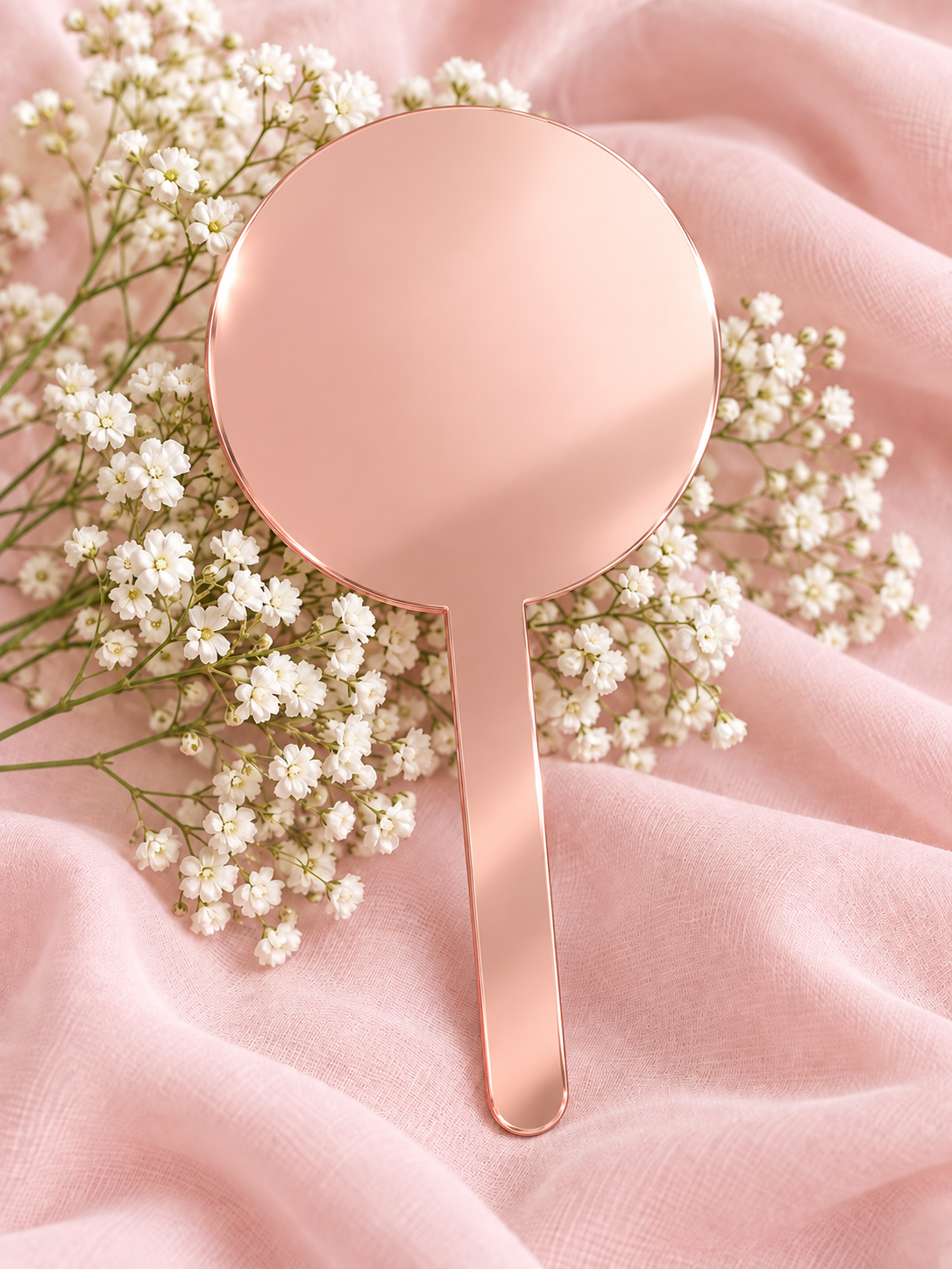 Rose Gold Mirror acrylic cake topper on soft pink fabric with baby's breath