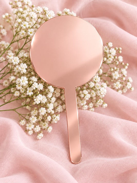 Rose Gold Mirror acrylic cake topper on soft pink fabric with baby's breath
