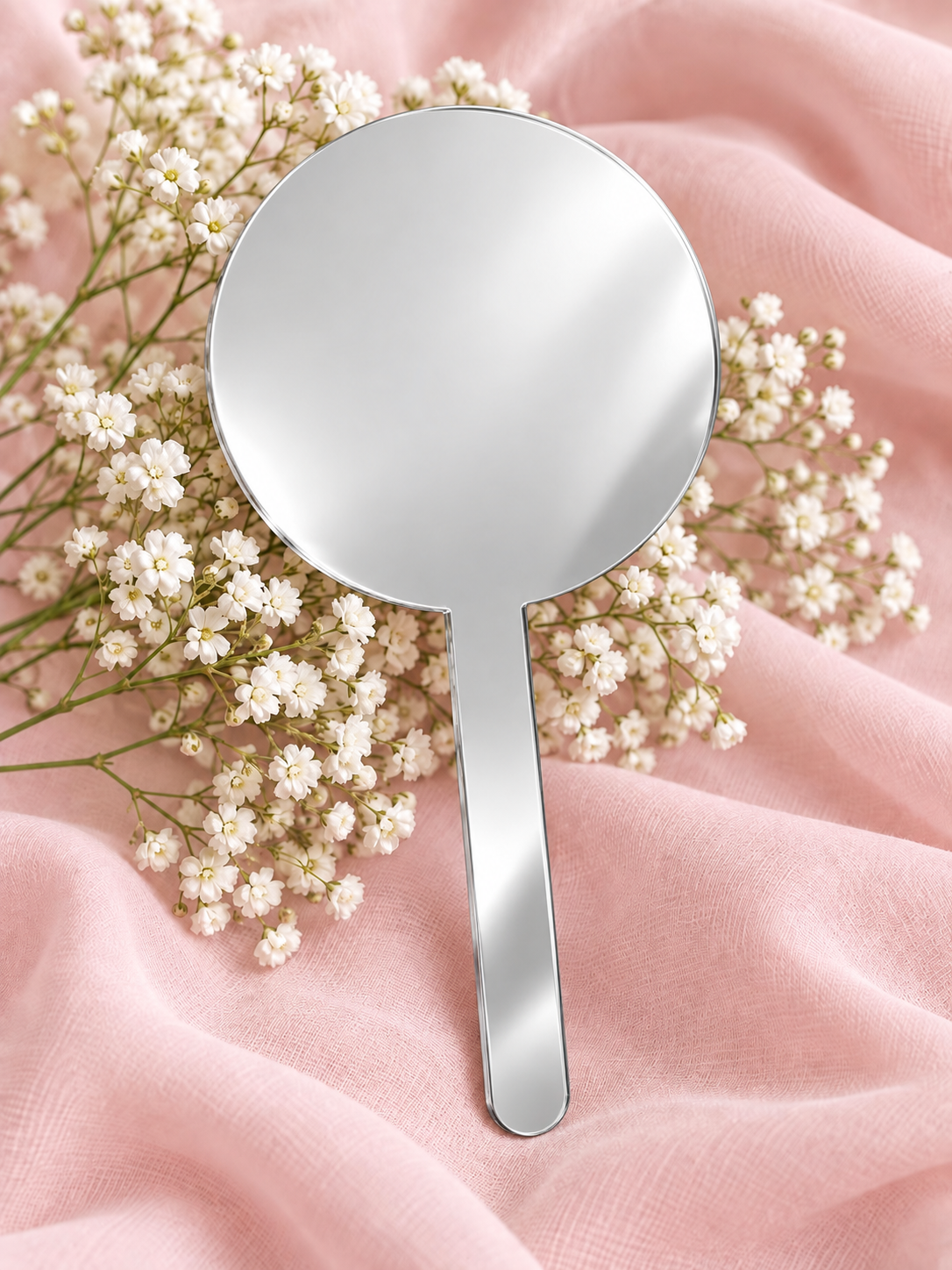Silver Mirror acrylic cake topper on soft pink fabric with baby's breath