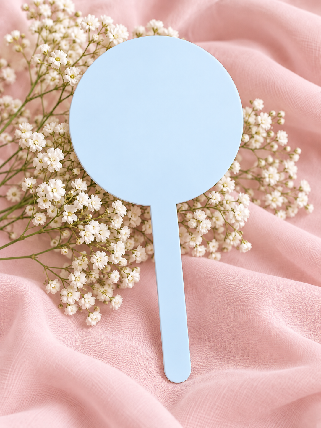 Baby Blue acrylic cake topper on soft pink fabric with baby's breath